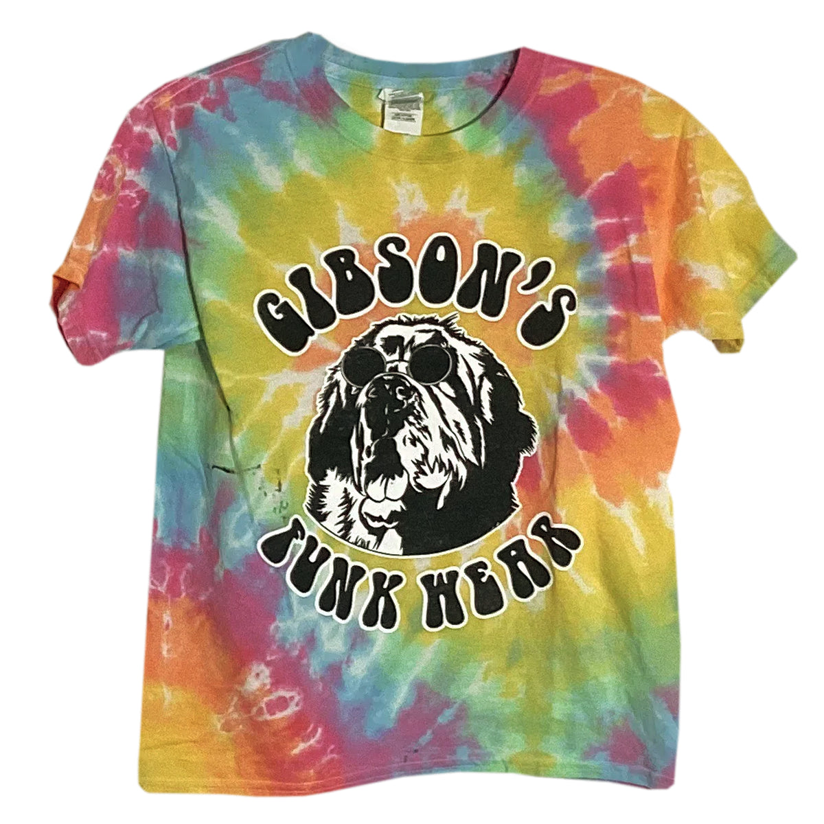Alt text: "Vibrant tie-dye T-shirt featuring a black and white print of a dog wearing sunglasses with the text 'Gibson's Funk Wear' in a bold circular design."