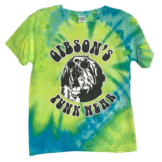 Alt text: "Kuai Delite" Gibson's Funk Wear T-shirt featuring a tie-dye design in green and blue with a graphic of a dog wearing sunglasses, and the text "GIBSON'S FUNK WEAR" in bold letters
